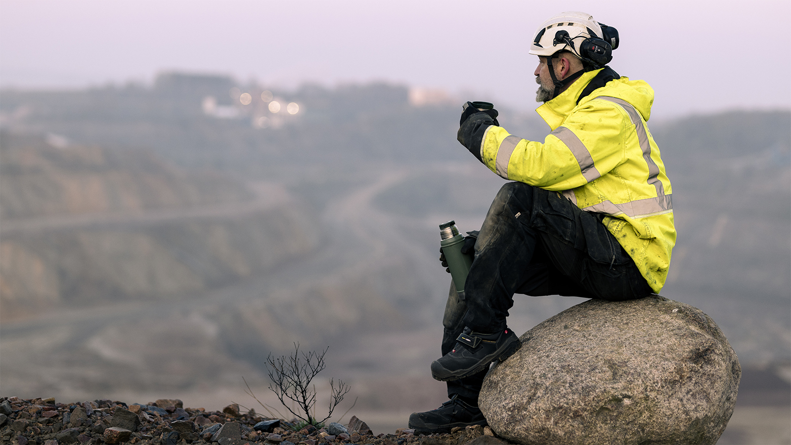 Quarry worker having a cup of morning coffee